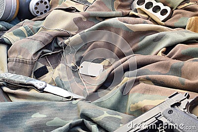 Stalker soldiers soviet gas mask lies with handgun and knife on green khaki camouflage jackets Stock Photo