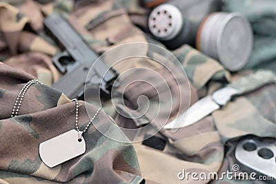 Stalker soldiers soviet gas mask lies with handgun and knife on green khaki camouflage jackets Stock Photo