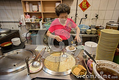 Stall vendor woman prepares taiwanese noodles for sale at her stall Editorial Stock Photo