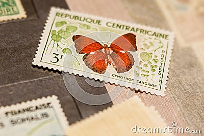 Stamp with butterfly among other stamps Editorial Stock Photo