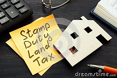 Stamp duty land tax SDLT memo and model of home. Stock Photo