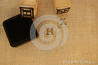 Stamp letters X and H on linen cloth Stock Photo