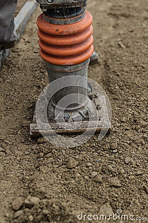 Stamping soil with rammer tool Stock Photo