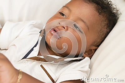 Stand-alone baby. Feeding infant with milk. Stock Photo