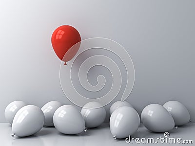Stand out from the crowd and different concepts One red balloon floating above other white balloons on white wall background Stock Photo