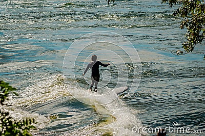 Stand up paddle board kayak sport and Surfing the St. Lawrence River Editorial Stock Photo