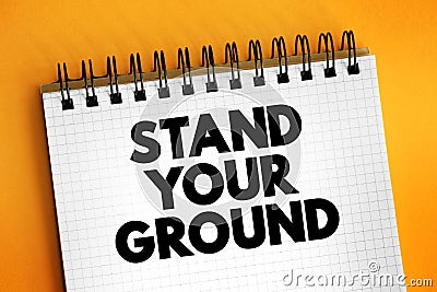 Stand Your Ground text on notepad, concept background Stock Photo