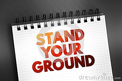 Stand Your Ground text on notepad, concept background Stock Photo