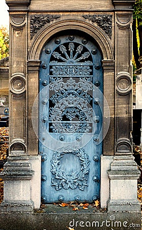Old blue iron entrance door of a tomb / crypt at a cemetery Stock Photo