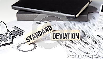 STANDARD DEVIATION - text on a wooden block with chart and notebook Stock Photo