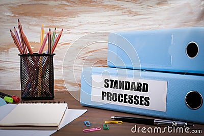 Standard Processes, Office Binder on Wooden Desk. On the table c Stock Photo