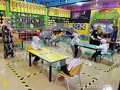 Standard 1 students are attending school by following the SOP of the Malaysian Ministry of Health at Editorial Stock Photo