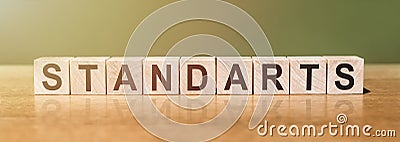 STANDARTS word written on wooden blocks on wooden table. Concept for your design Stock Photo