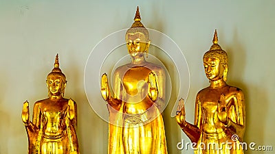 Standing Buddhas in Gold look antique in Wat Pho Stock Photo