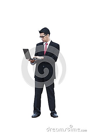 Standing businessman using laptop Stock Photo