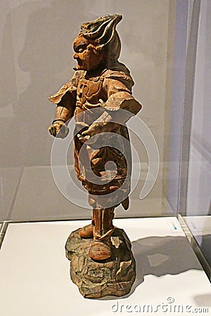 Standing Figure of Buddhist Guardian, 13th-14th century. Wood sculpture Editorial Stock Photo