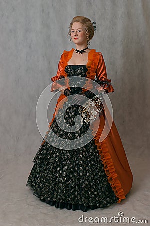 Standing girl in baroque dress Stock Photo