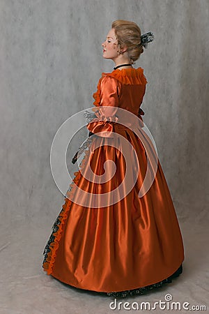 Standing girl in baroque dress Stock Photo