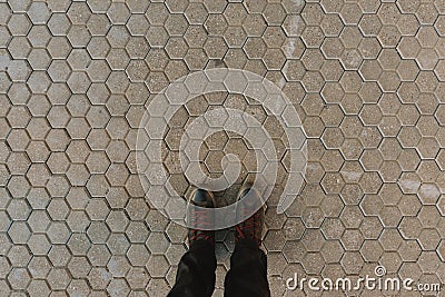 Standing on hexagonal concrete pavement tiles background Stock Photo