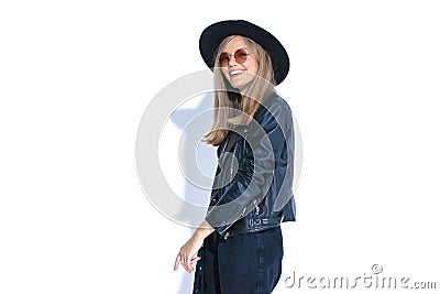 Standing hippie girl with hat and leather jacket laughing Stock Photo