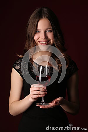 Standing lady with bocal. Close up. Dark red background Stock Photo