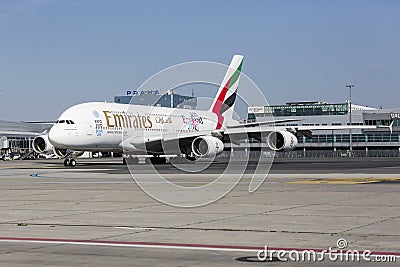 A standing plane of Emirates Airline on a runway Editorial Stock Photo