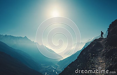 Standing woman on the hill against mountain valley Stock Photo