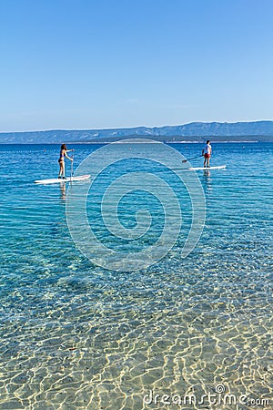 Standup paddle boarders at Zlatni Rat beach, Croatia Editorial Stock Photo