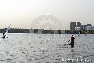 Standup paddleboarding are on the river Moscow, Strogino Editorial Stock Photo