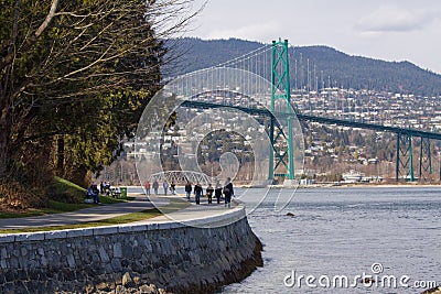 Stanley Park seawall with iconic Lions Gate Bridge Editorial Stock Photo