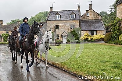 Unidentified people and horses near cottages in the village of Stanton, Cotswolds district of Gloucestershire. Editorial Stock Photo