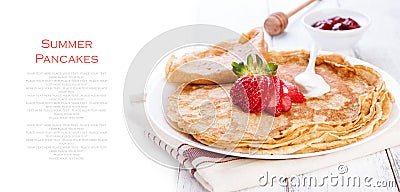 Staple of wheat golden yeast pancakes or crepes, traditional for Russian pancake week, with fresh strawberry on a wooden table Stock Photo