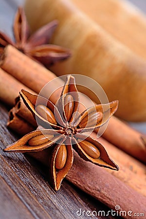 Star anise with cinnamon sticks and bowl on table Stock Photo