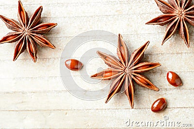 Star anise fruits on the wooden board, top view Stock Photo