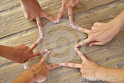 Star shape with six hand fingers on a beach Stock Photo