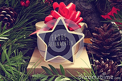 Star-shaped chalkboard with the text Frohe Weihnachten, Merry Ch Stock Photo