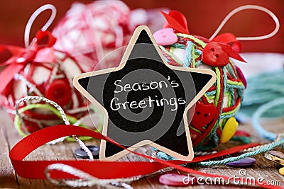 Star-shaped chalkboard with the text seasons greetings Stock Photo