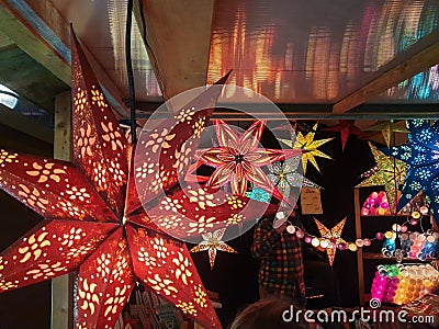 Star-shaped Paper lamp shades in a stall at a Christmas Market near Liverpool Lime Street Train Station Editorial Stock Photo