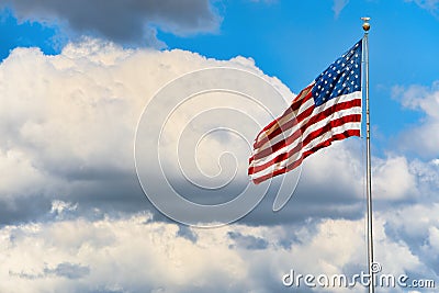 Star-striped American flag flutters proudly against the blue sky Stock Photo