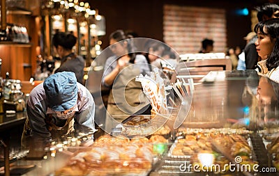 A Starbucks barista making coffee for their customer at the Starbucks Reserve Roastery in Shanghai Editorial Stock Photo