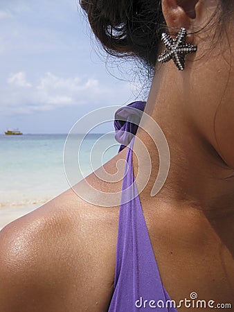 Starfish earing woman on beach Stock Photo