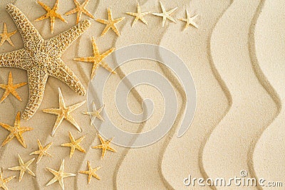 Starfish on golden beach sand with wavy lines Stock Photo