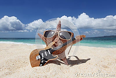 Starfish guitar player on beach Stock Photo