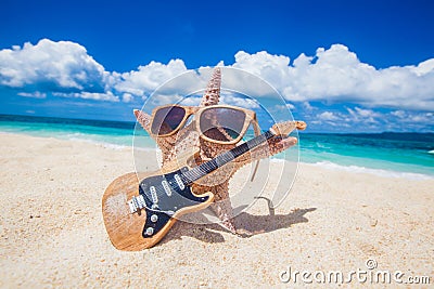 Starfish guitar player on beach Stock Photo