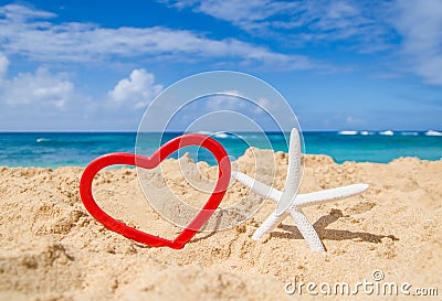 Starfish with heart shape on the sandy beach Stock Photo