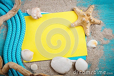 Starfish, pebbles and shells lying on a blue wooden background with postcard. There is a place for labels. Stock Photo