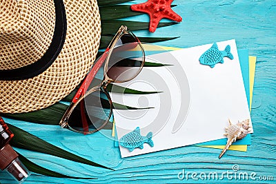 Starfish, pebbles and shells lying on a blue wooden background with postcard. There is a place for labels. Stock Photo