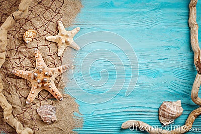 Starfish, pebbles and shells lying on a blue wooden background . There is a place for labels. Stock Photo