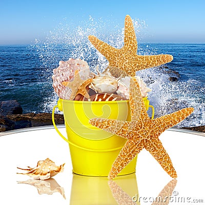 Starfish & Sea Shells In Yellow Beach Bucket Stock Photo