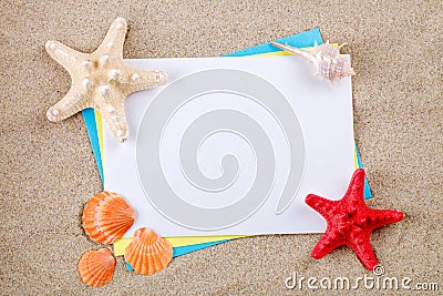 Starfish and seashells lying on the sand on the postcard. Stock Photo